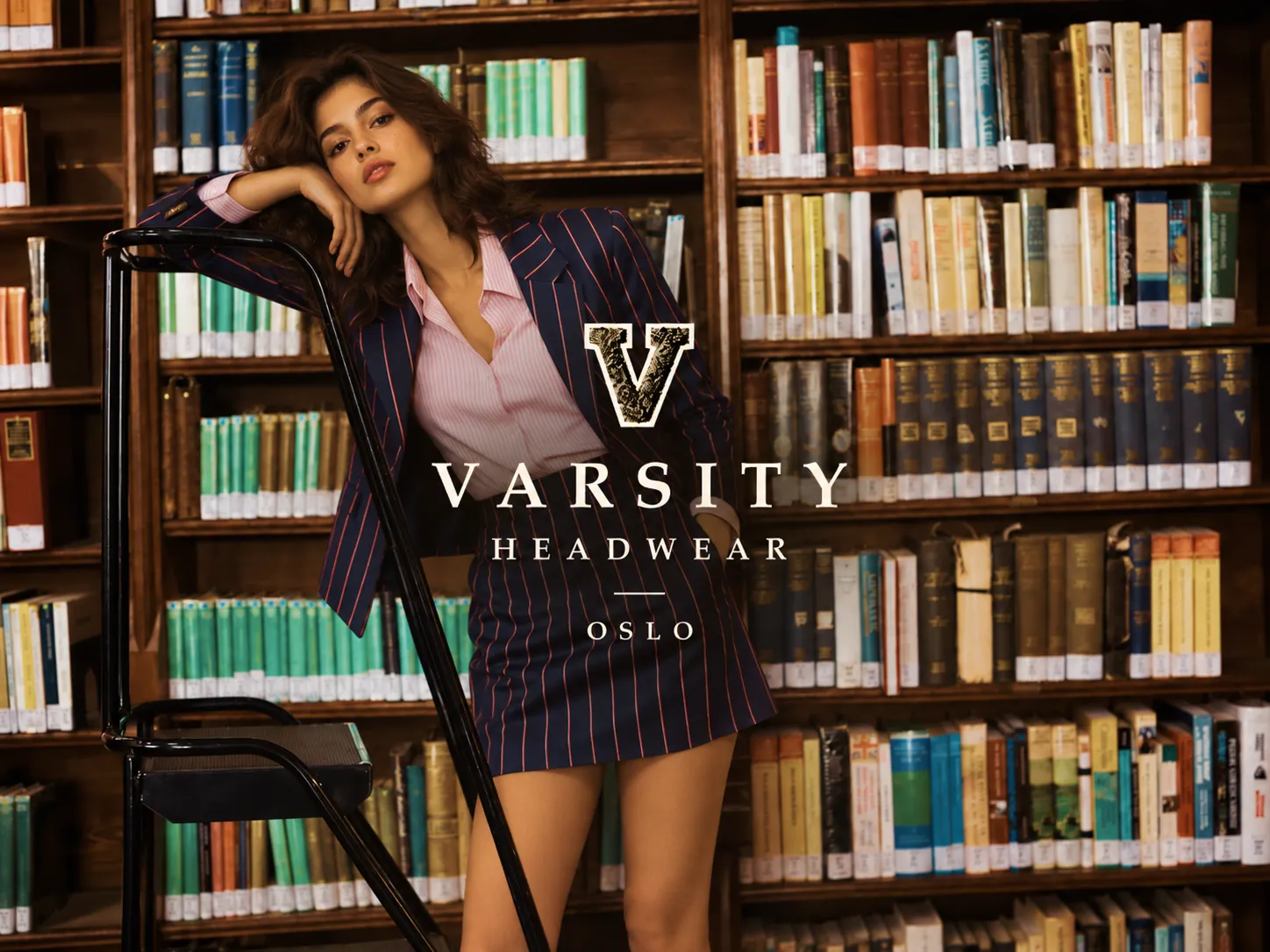 Varsity Headwear fashion image with a model in a library